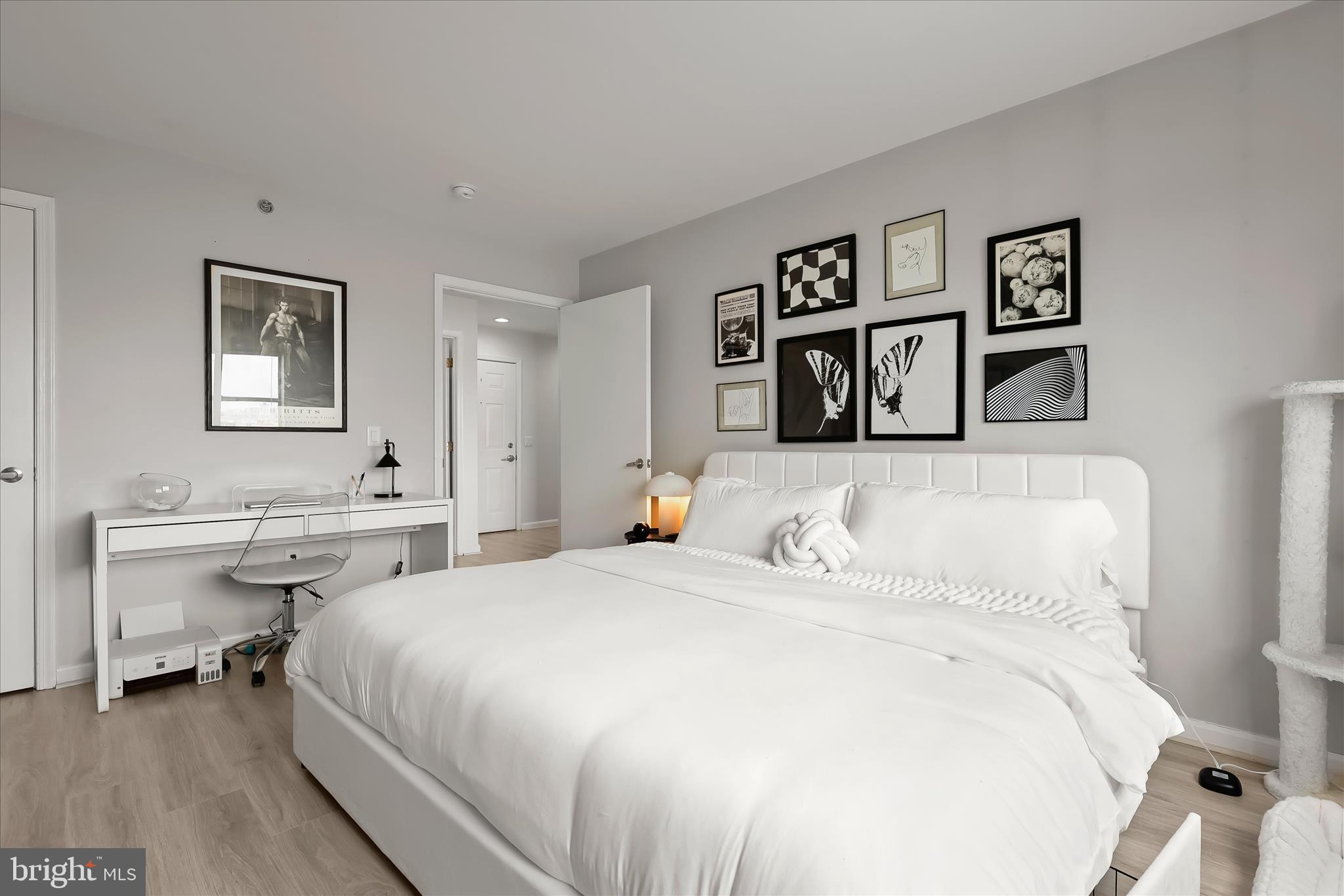 2702 Lighthouse Point East, Unit 522 Baltimore, MD 21224 - Photo 26 of 50 a bedroom with a bed and a desk