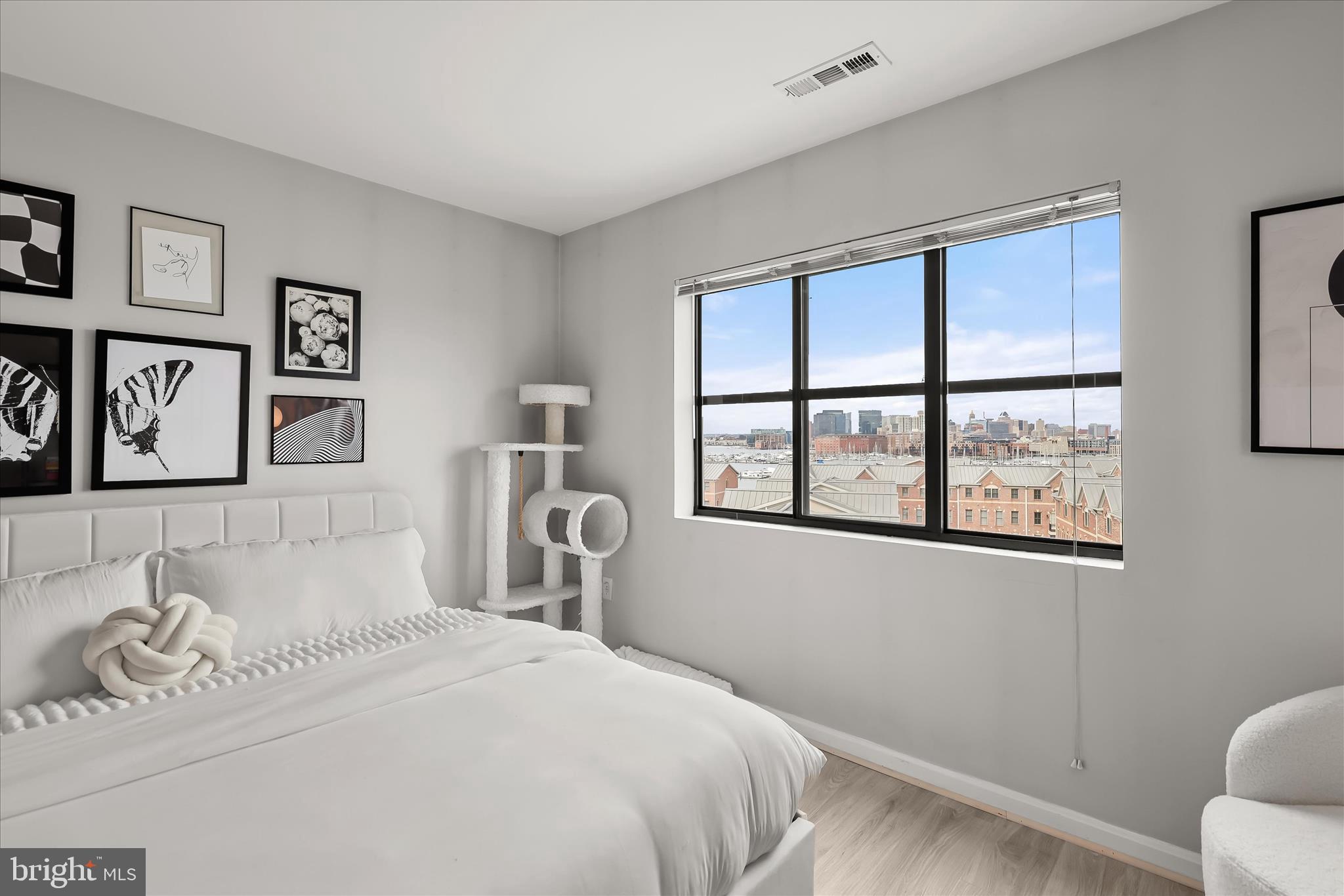 2702 Lighthouse Point East, Unit 522 Baltimore, MD 21224 - Photo 27 of 50 a bedroom with a bed and a window