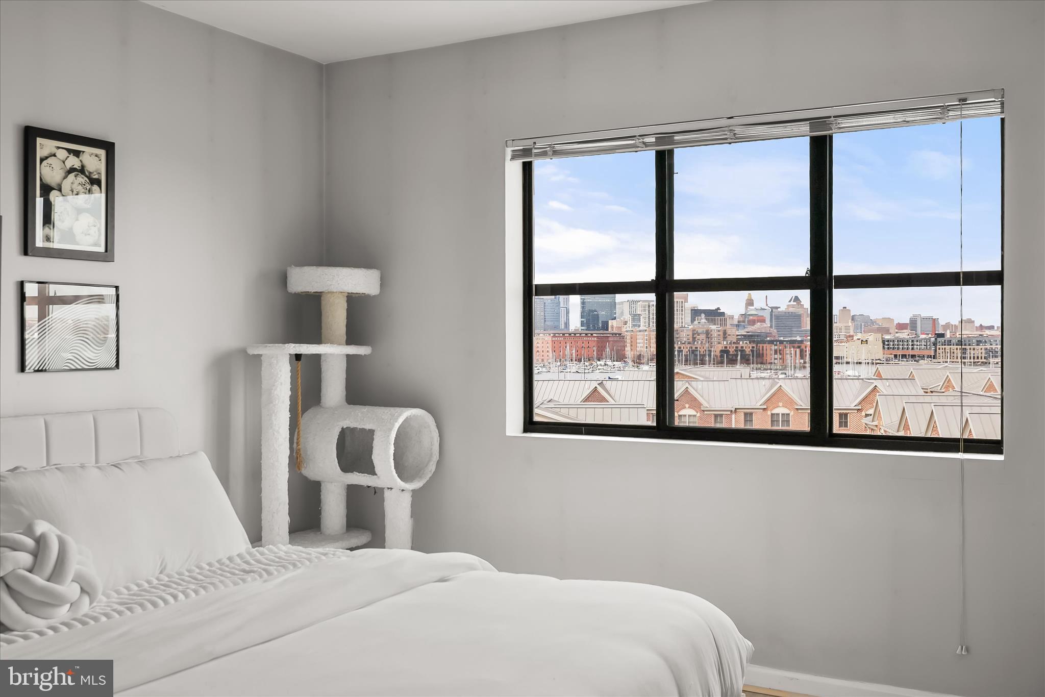 2702 Lighthouse Point East, Unit 522 Baltimore, MD 21224 - Photo 28 of 50 a bedroom with a large bed and a window