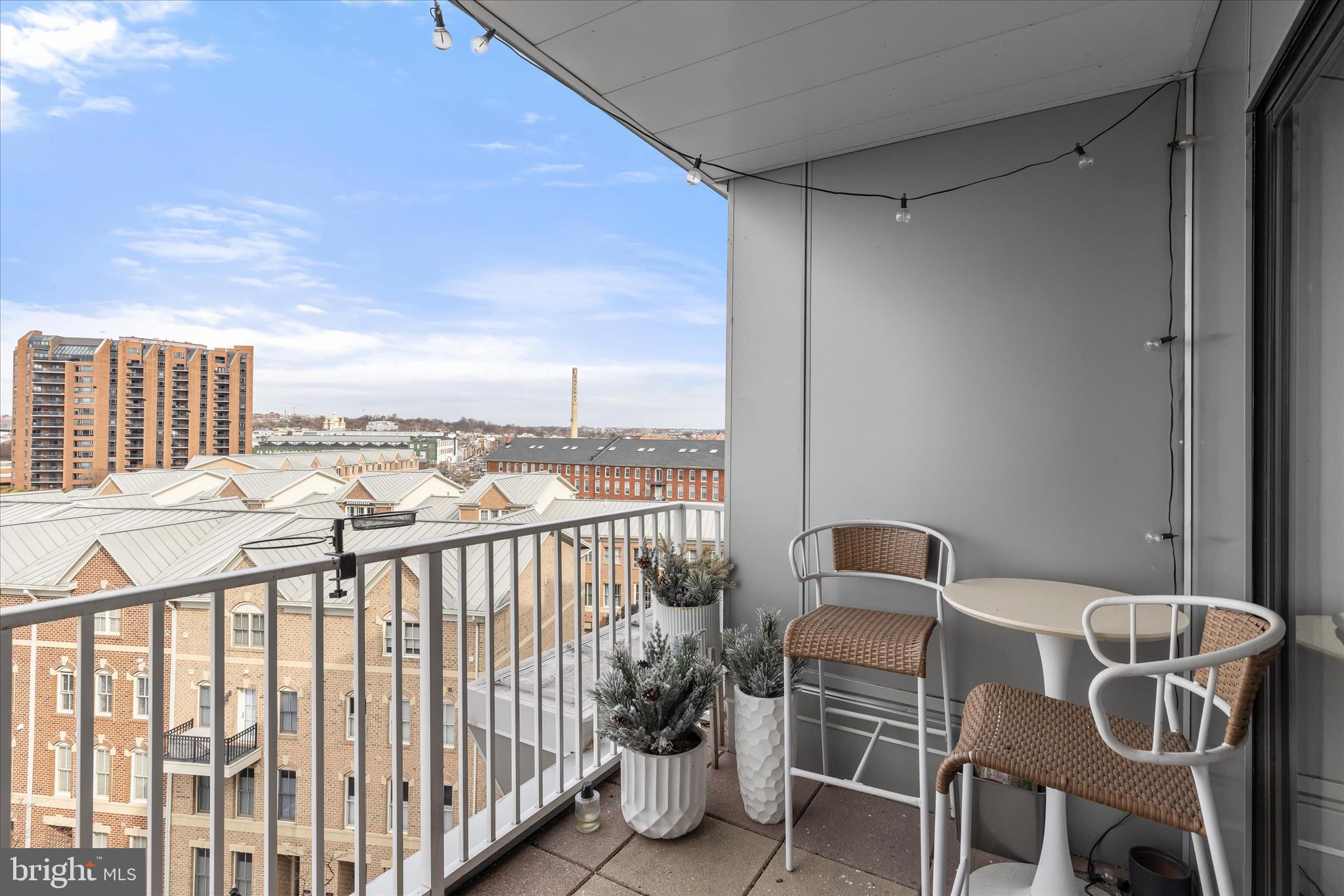 2702 Lighthouse Point East, Unit 522 Baltimore, MD 21224 - Photo 30 of 50 a balcony with table and chairs