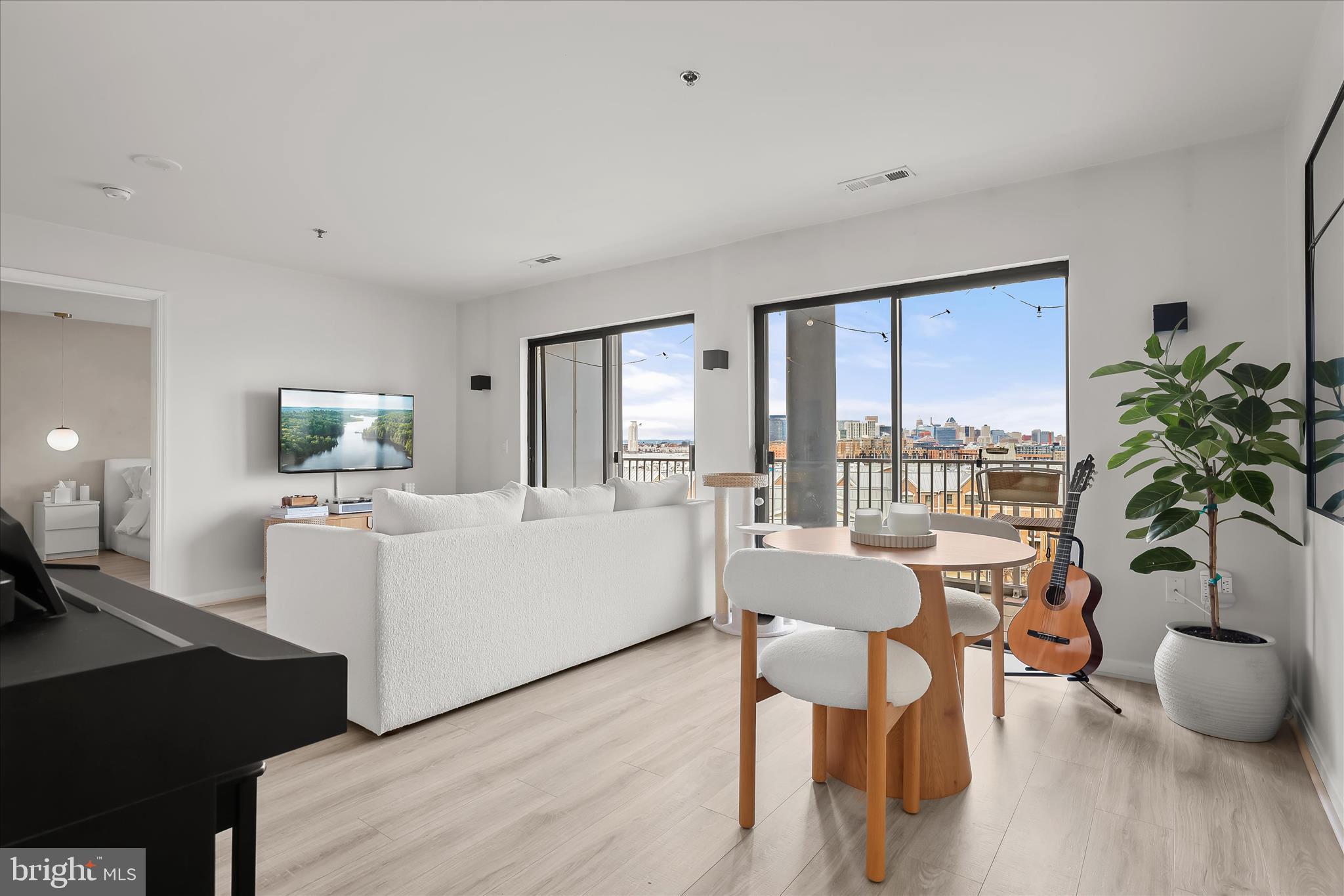 2702 Lighthouse Point East, Unit 522 Baltimore, MD 21224 - Photo 3 of 50 a living room with furniture and a large window