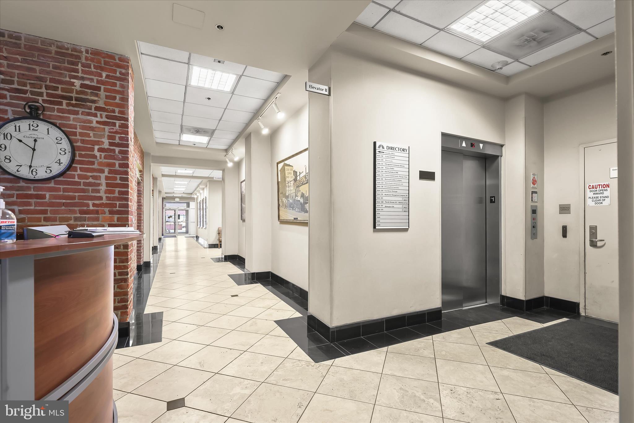 2702 Lighthouse Point East, Unit 522 Baltimore, MD 21224 - Photo 37 of 50 a hallway with dining table and chairs