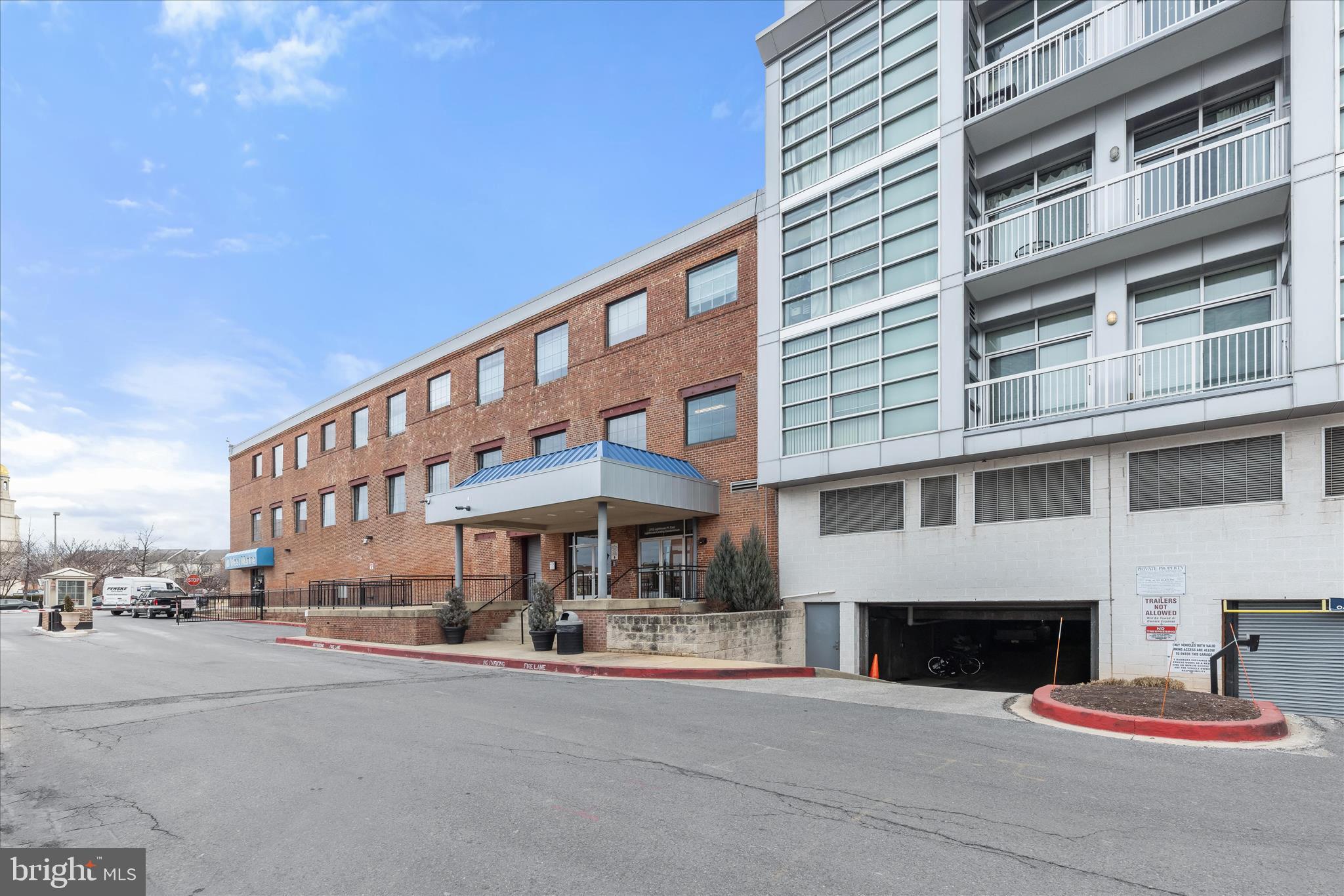 2702 Lighthouse Point East, Unit 522 Baltimore, MD 21224 - Photo 40 of 50 a front view of a building with street