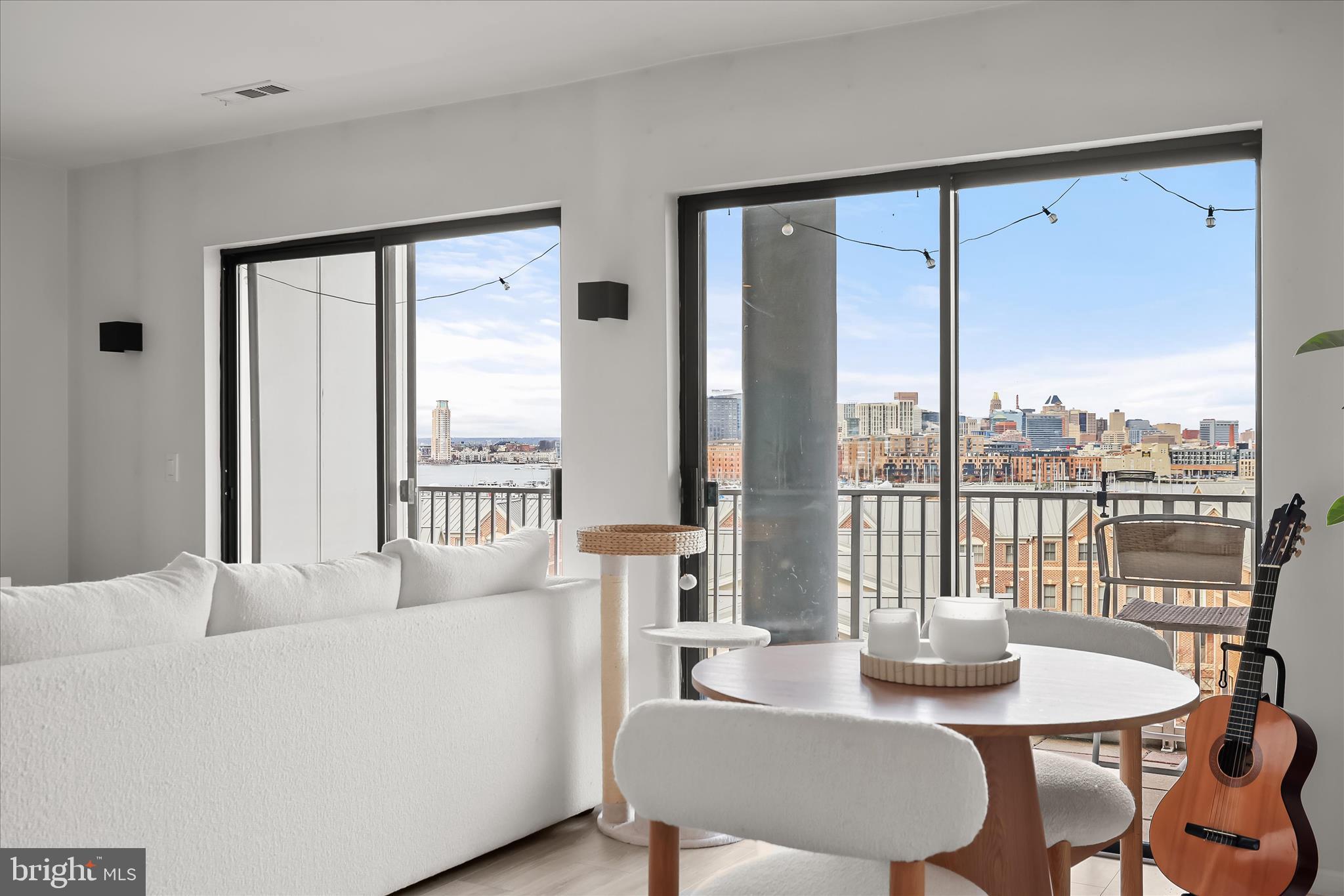 2702 Lighthouse Point East, Unit 522 Baltimore, MD 21224 - Photo 4 of 50 a living room with furniture and a large window