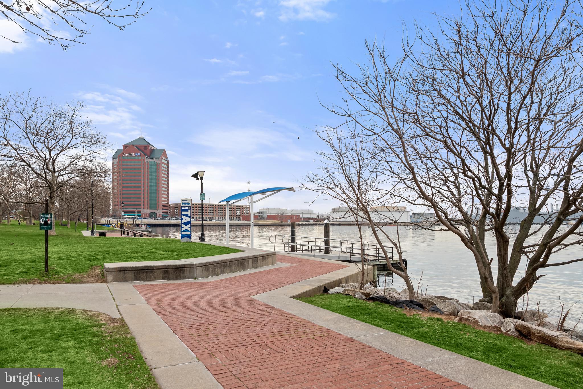 2702 Lighthouse Point East, Unit 522 Baltimore, MD 21224 - Photo 46 of 50 a front view of a house with garden and trees