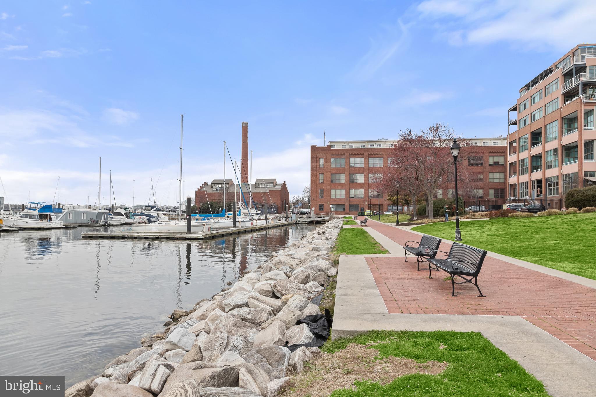 2702 Lighthouse Point East, Unit 522 Baltimore, MD 21224 - Photo 47 of 50 a small view of a lake with a table and chairs
