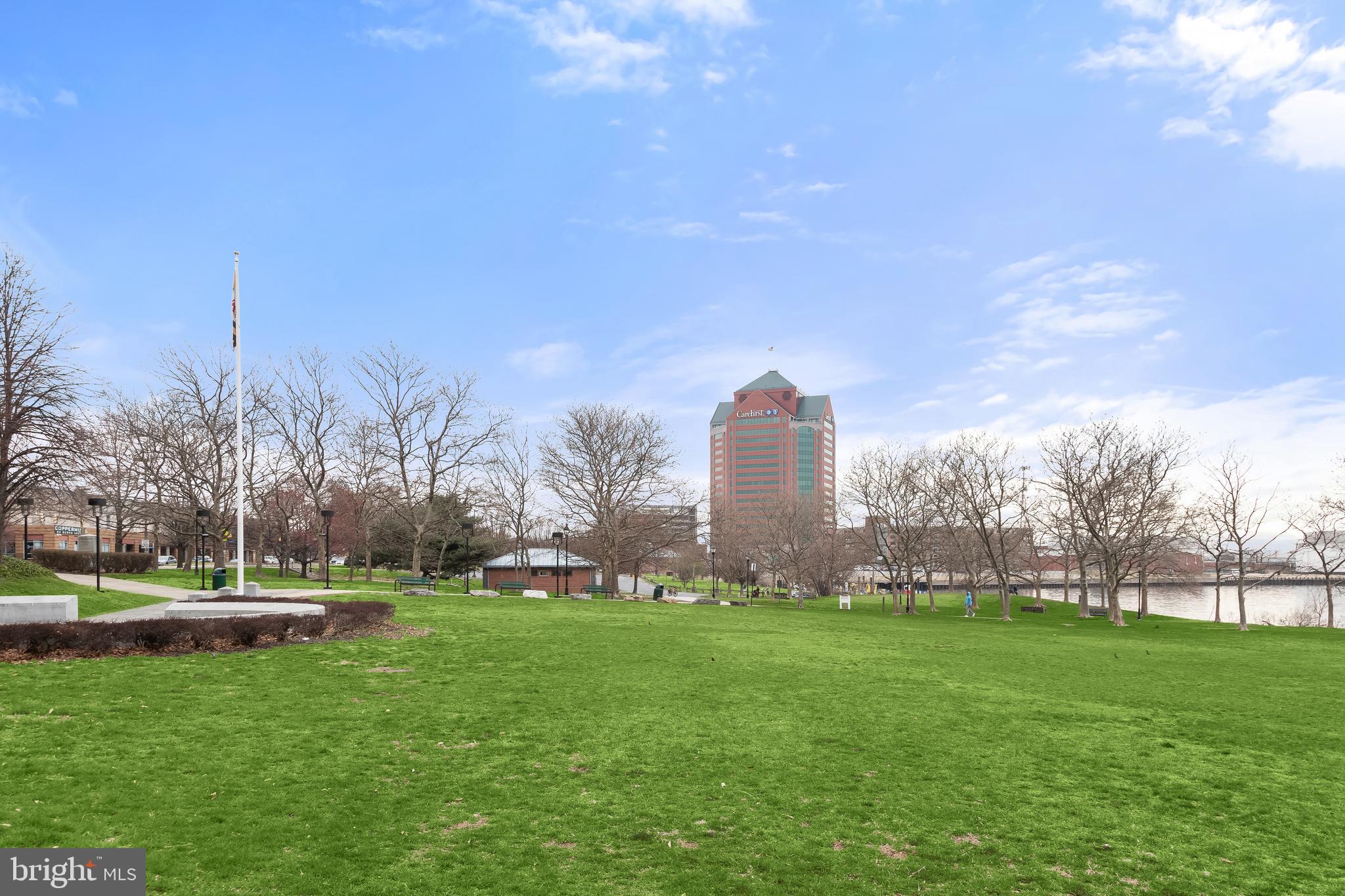 2702 Lighthouse Point East, Unit 522 Baltimore, MD 21224 - Photo 48 of 50 a view of a building with a big yard and large trees