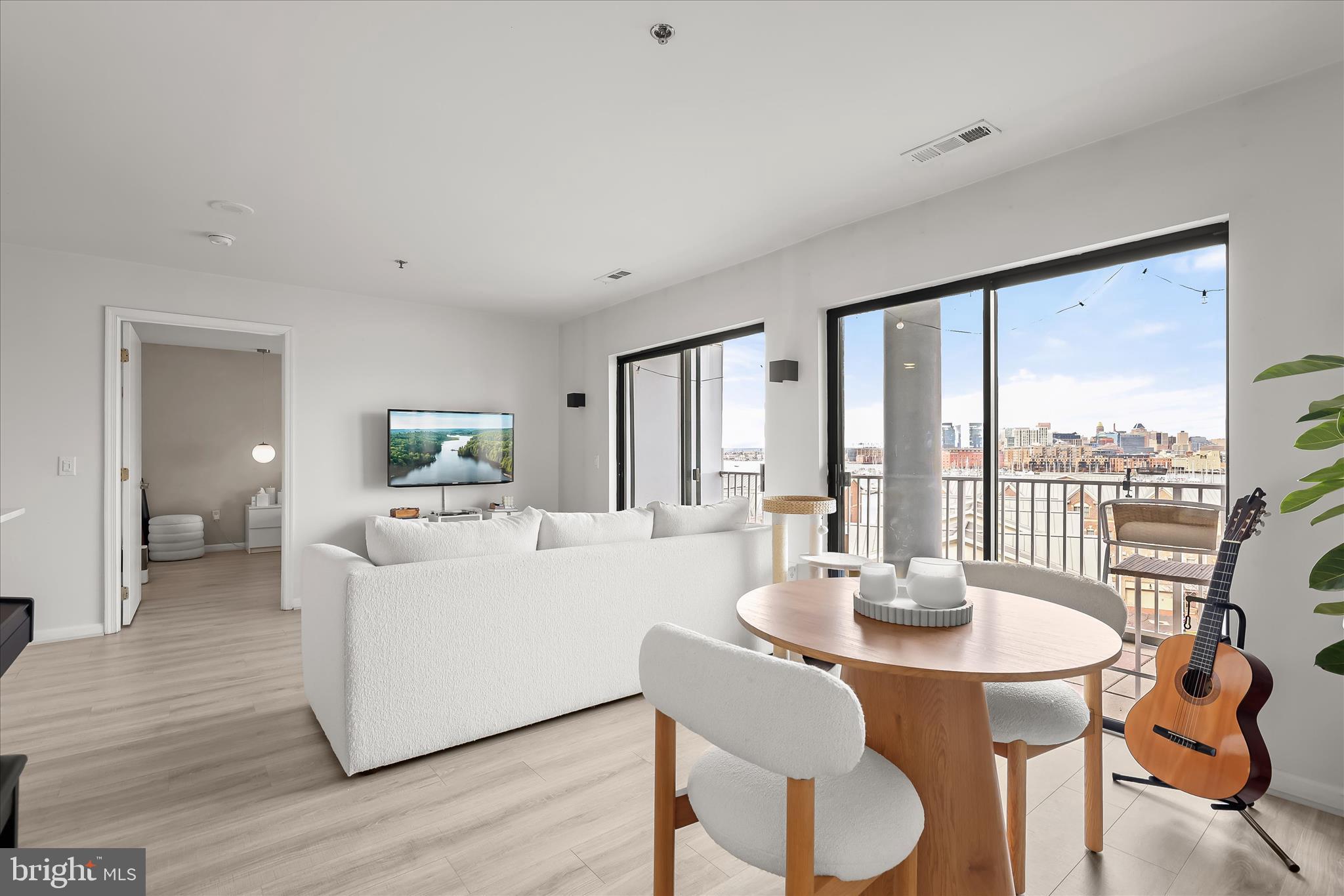 2702 Lighthouse Point East, Unit 522 Baltimore, MD 21224 - Photo 5 of 50 a living room with furniture and a large window