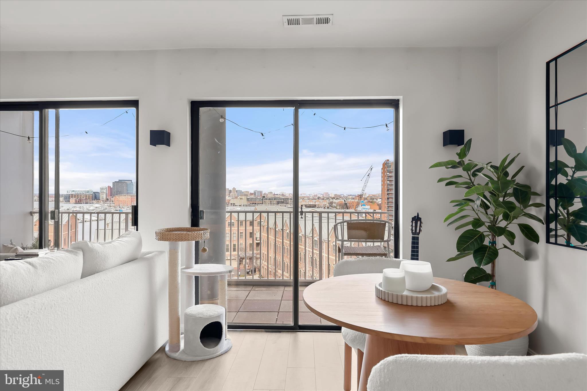 2702 Lighthouse Point East, Unit 522 Baltimore, MD 21224 - Photo 6 of 50 a living room with furniture and a potted plant