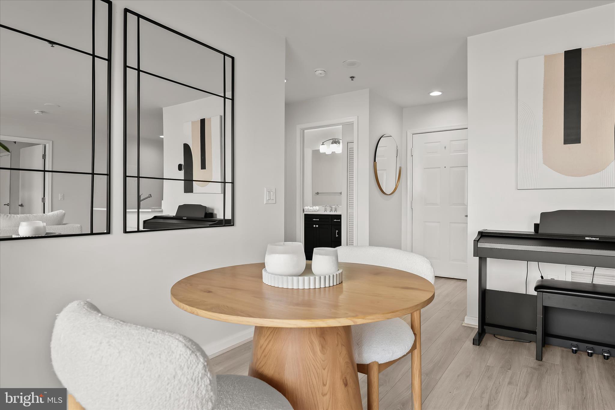2702 Lighthouse Point East, Unit 522 Baltimore, MD 21224 - Photo 7 of 50 a kitchen with a table and chairs in it