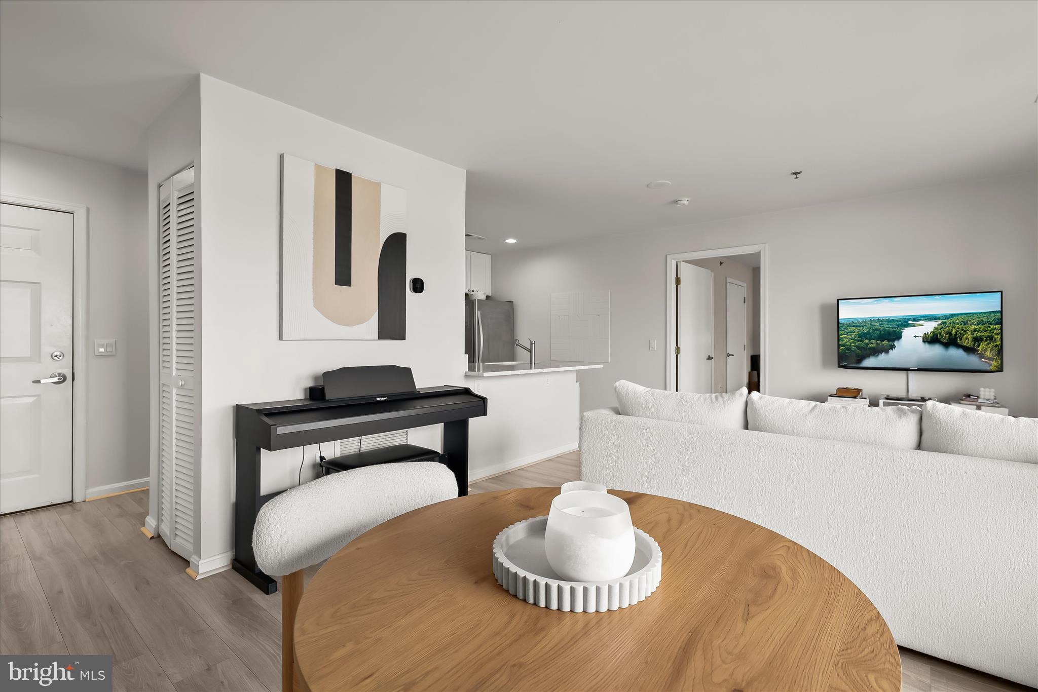 2702 Lighthouse Point East, Unit 522 Baltimore, MD 21224 - Photo 8 of 50 a living room with furniture and a wooden floor