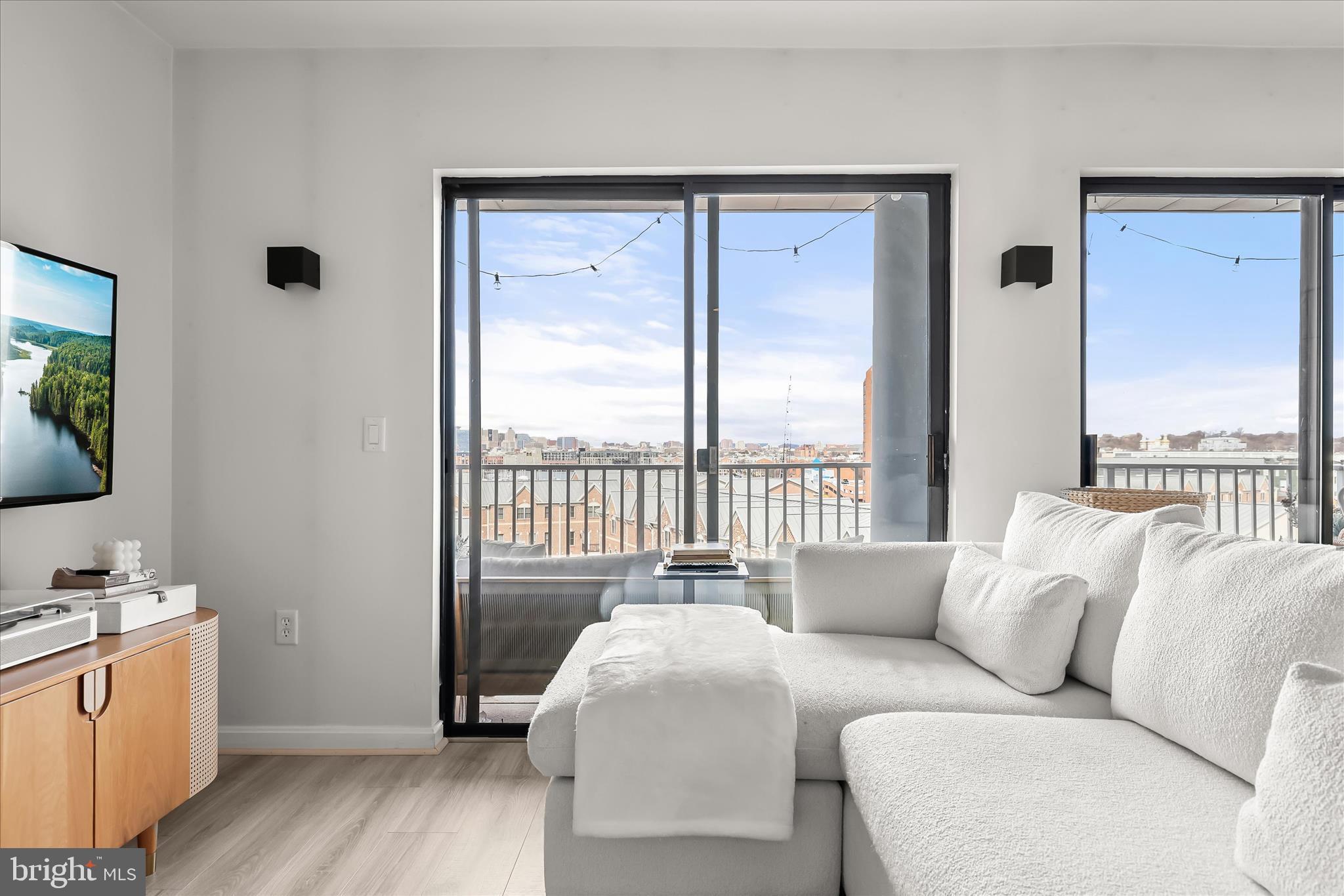 2702 Lighthouse Point East, Unit 522 Baltimore, MD 21224 - Photo 10 of 50 a living room with furniture and a window
