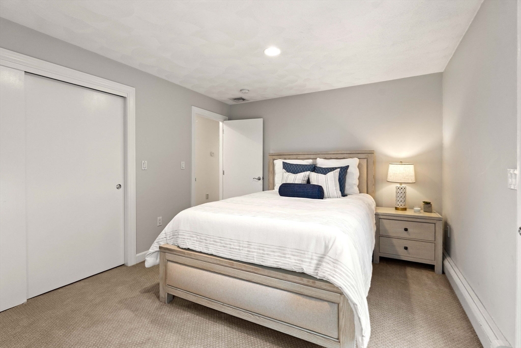 53 Gerald Road Marblehead, MA 01945 - Photo 27 of 42 a bedroom with a bed and a night stand