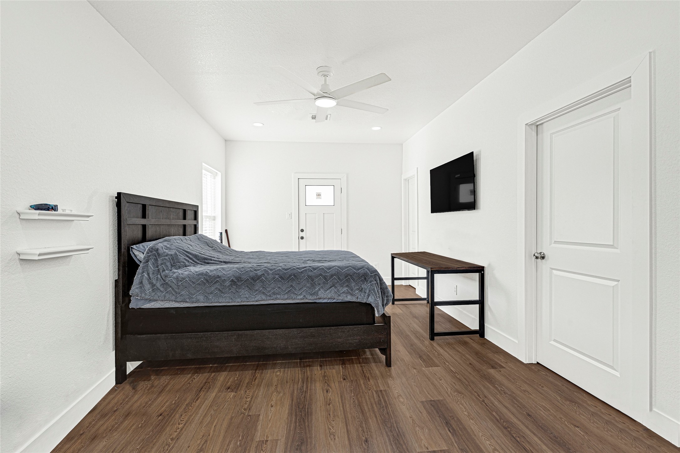 1107 Brooks Street Houston, TX 77009 - Photo 11 of 30 a bedroom with a bed a flat screen tv and a dresser