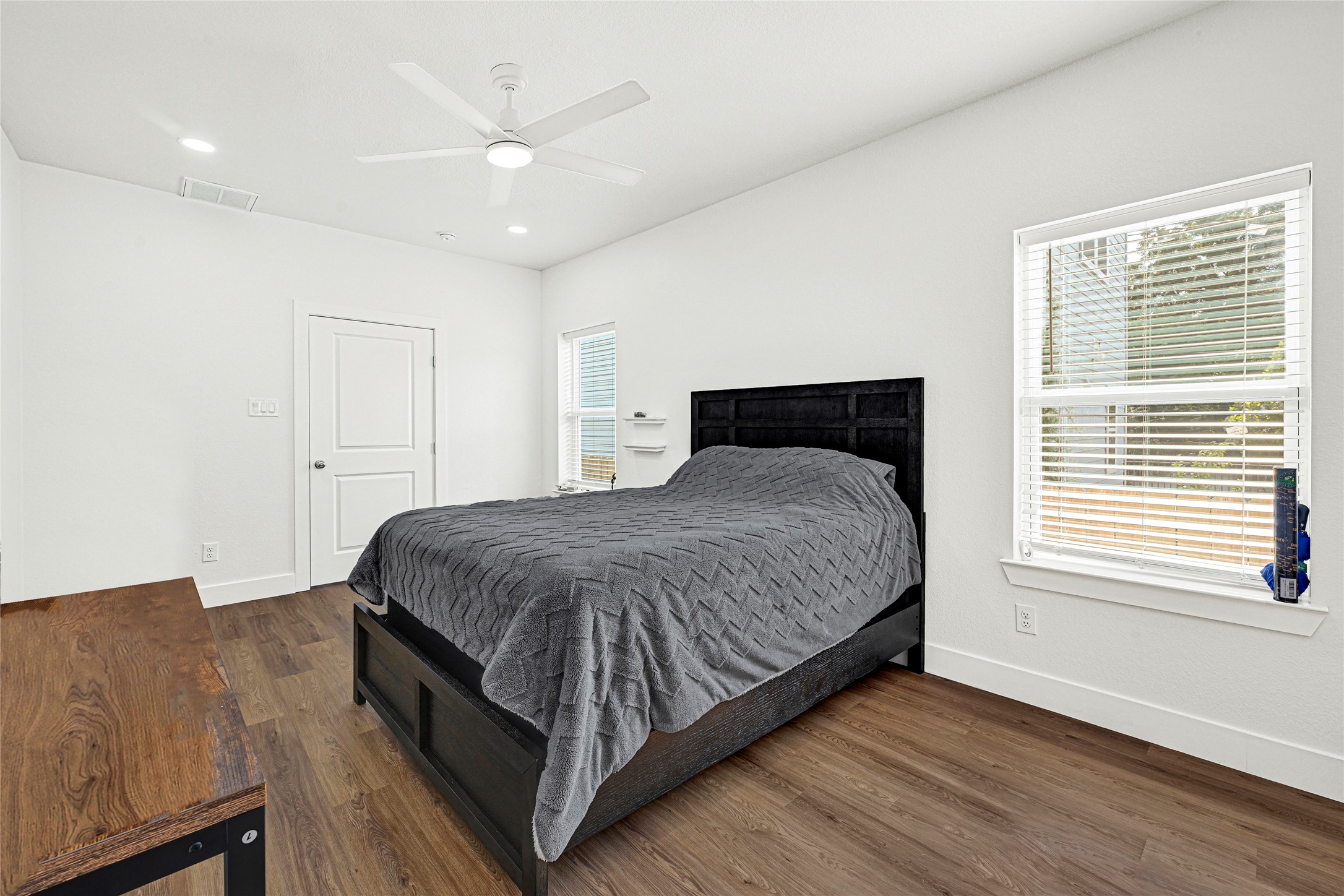 1107 Brooks Street Houston, TX 77009 - Photo 12 of 30 a bedroom with a large bed chandelier and a window