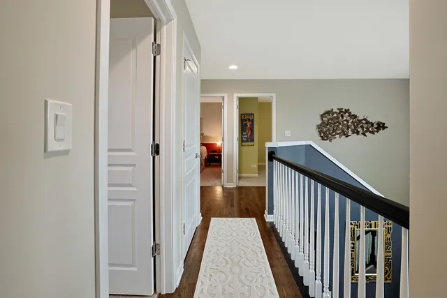 a view of a hallway with wooden floor and entryway