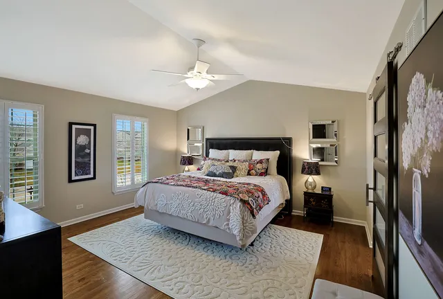 a bedroom with a large bed and a window