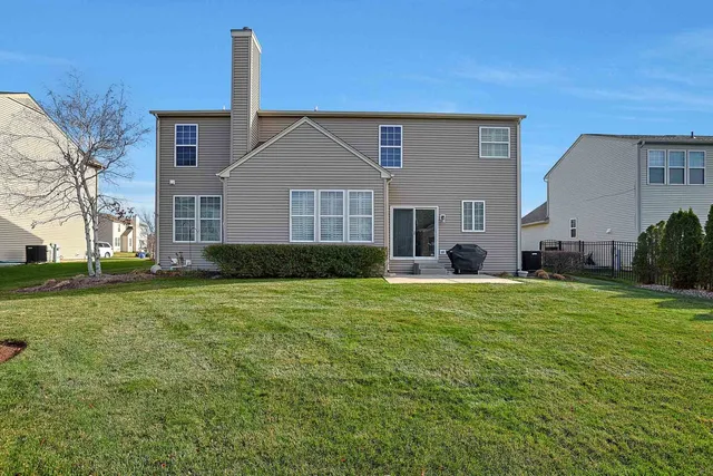 a front view of house with yard and trees