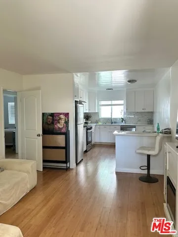 a kitchen with a refrigerator and a sink