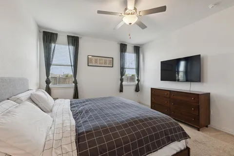 a bedroom with a bed and a flat screen tv