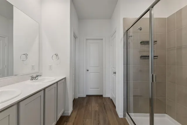 a bathroom with a double vanity sink and mirror