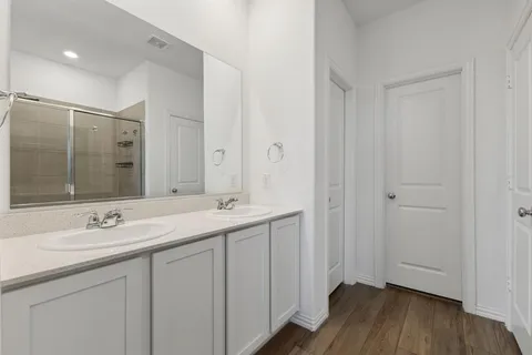 a bathroom with a double vanity sink and mirror