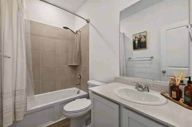 a bathroom with a sink toilet and shower