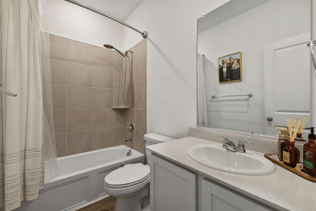 705 Alden Drive Princeton, TX 75407 - Photo 18 of 26 a bathroom with a sink toilet and shower