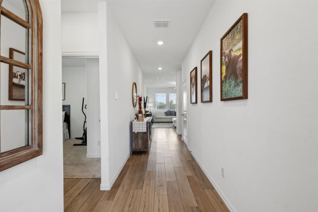 705 Alden Drive Princeton, TX 75407 - Photo 2 of 26 a view of a hallway with wooden floor and staircase