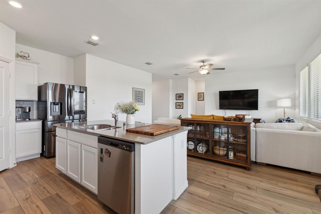 705 Alden Drive Princeton, TX 75407 - Photo 25 of 26 a kitchen with stainless steel appliances kitchen island a sink stove and refrigerator