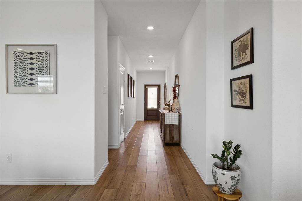 705 Alden Drive Princeton, TX 75407 - Photo 3 of 26 a view of a hallway with wooden floor and a potted plant