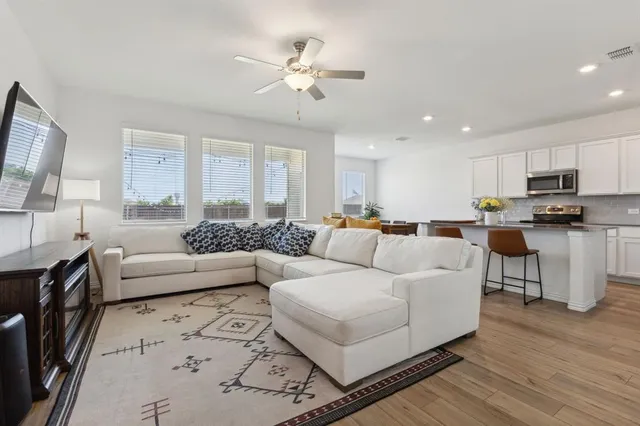 a living room with furniture and a large window