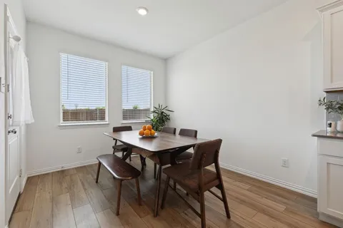 a view of a workspace with furniture and wooden floor