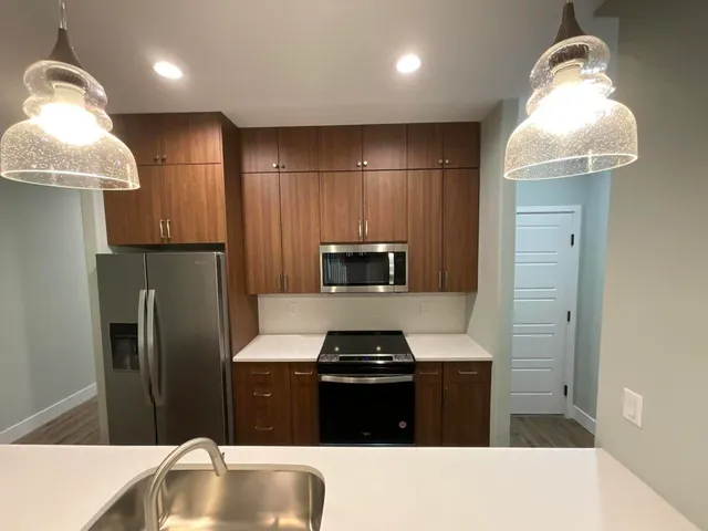 a kitchen with a refrigerator and a sink