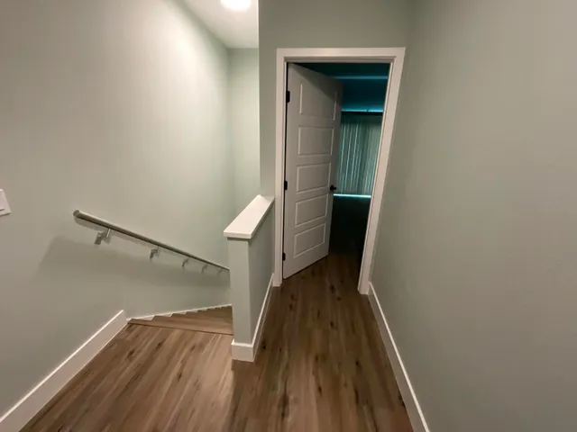 a view of a room with wooden floor