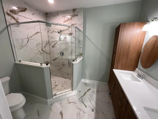 a bathroom with a sink toilet and shower