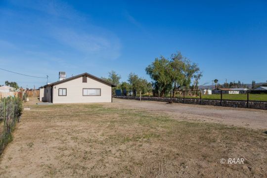 148 South Sunset Street Ridgecrest, CA 93555 - Photo 4 of 25 a view of a house with a yard