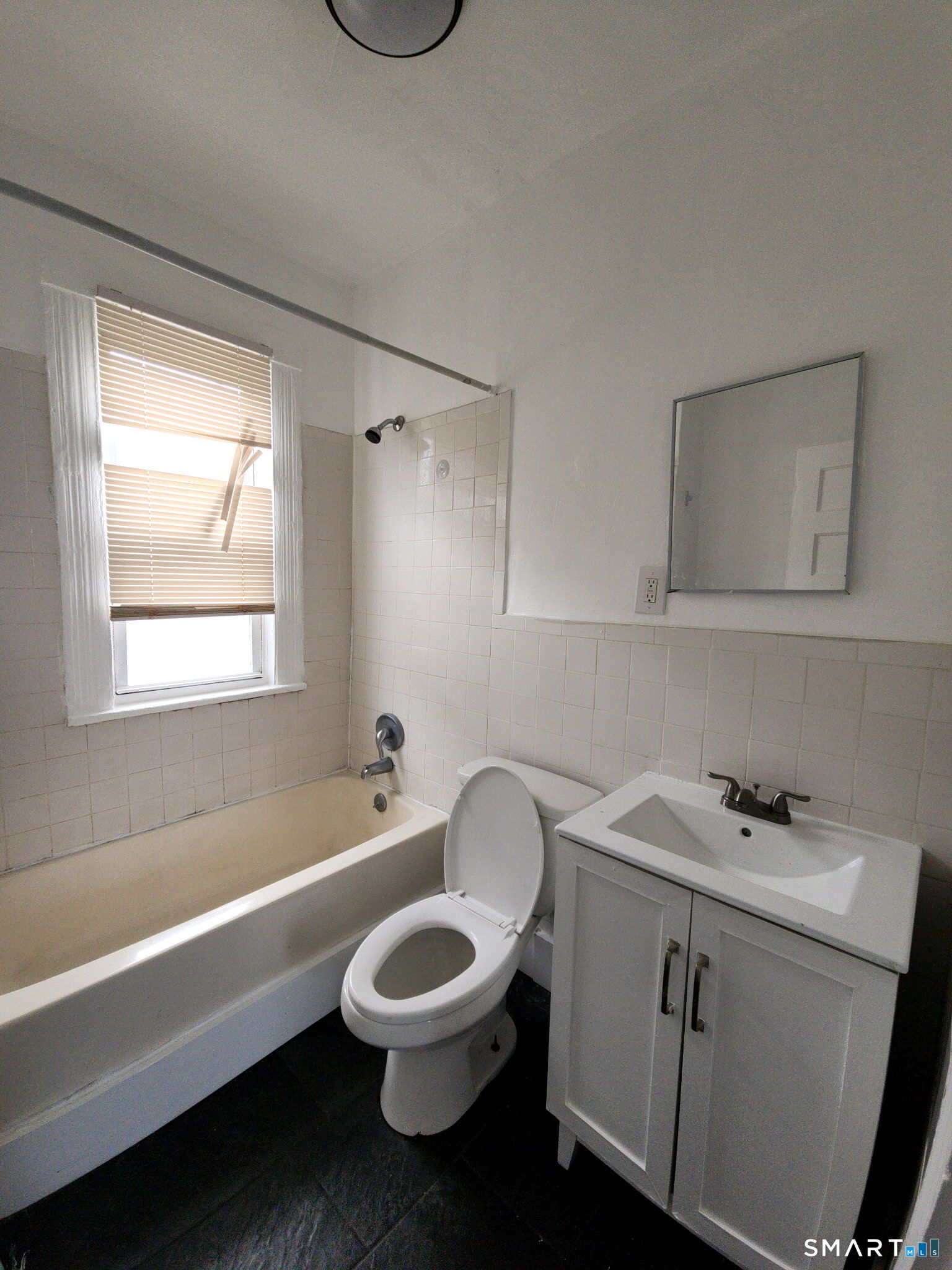 93-95 Baldwin Street, Unit 2 Bridgeport, CT 06607 - Photo 5 of 9 a bathroom with a sink and a bathtub