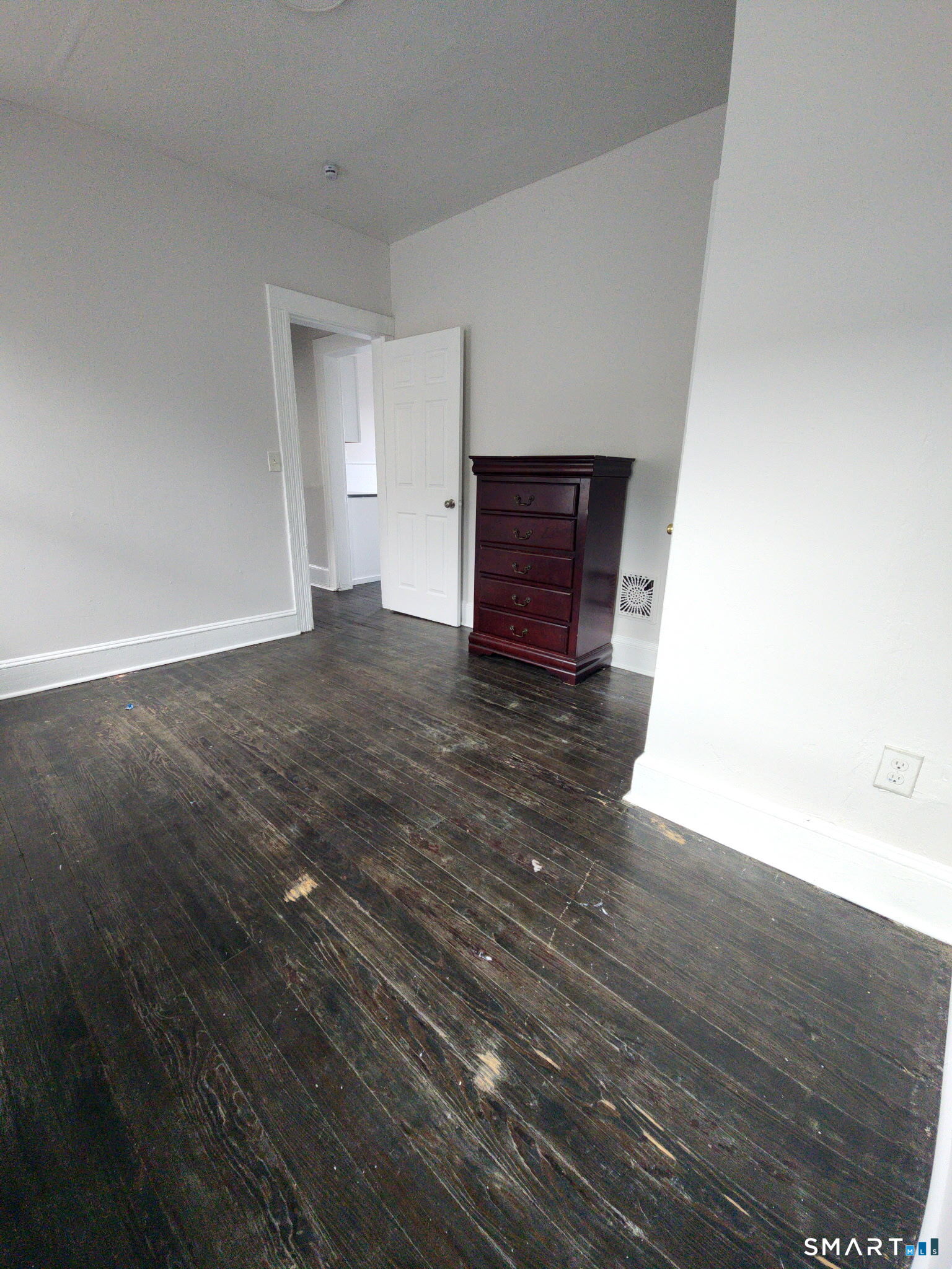 93-95 Baldwin Street, Unit 2 Bridgeport, CT 06607 - Photo 9 of 9 a view of an empty room with wooden floor and a window