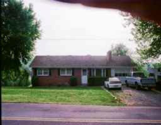 12794 Hardy Road Hardy, VA 24101 - Photo 1 of 1 a front view of a house with a garden and trees