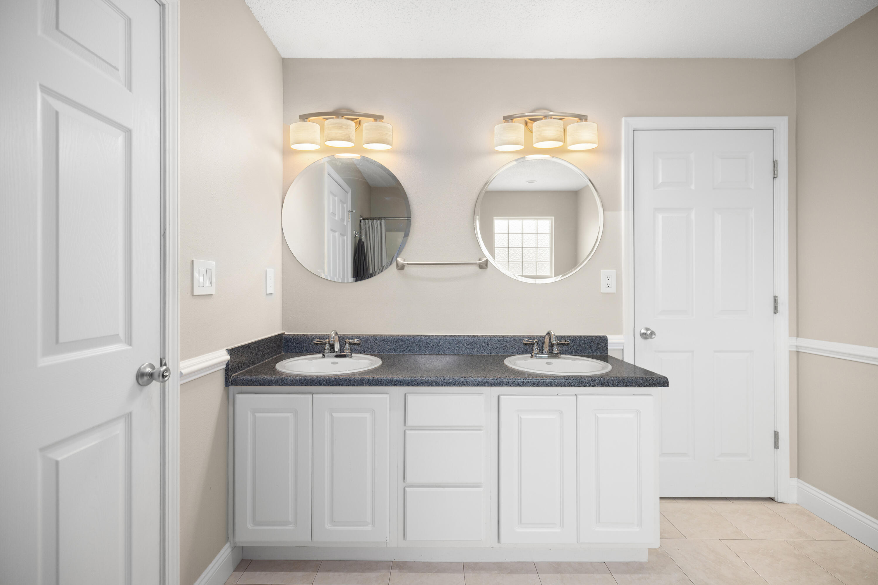 202 Limestone Circle Crestview, FL 32539 - Photo 23 of 49 a bathroom with double vanity sinks and a mirror