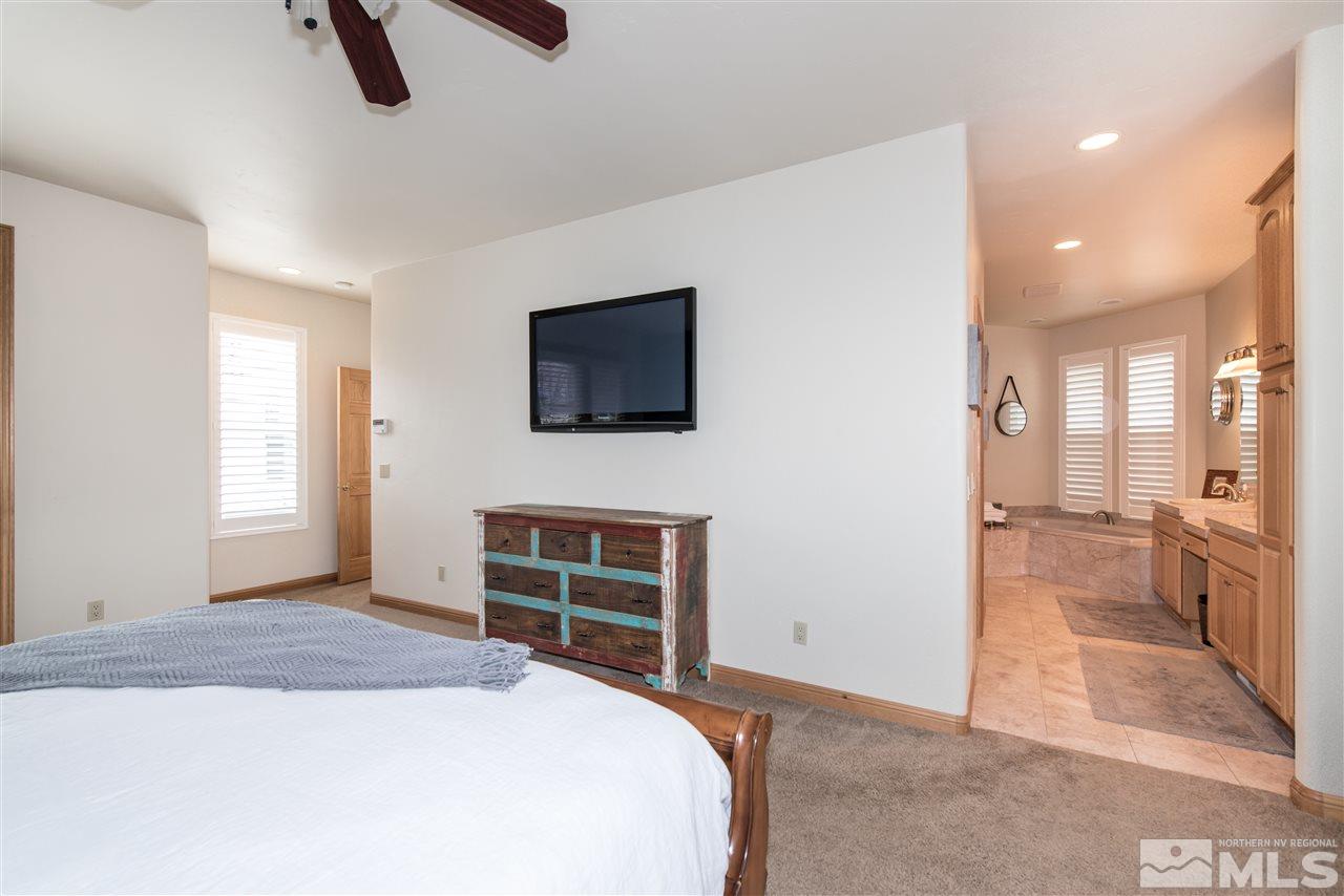 1199 Yates Lane Reno, NV 89509 - Photo 15 of 25 a bedroom with a bed and a flat screen tv