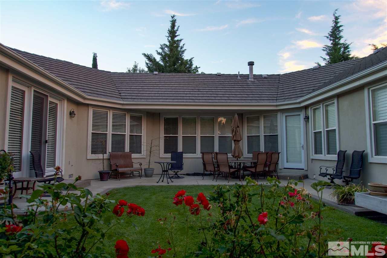 1199 Yates Lane Reno, NV 89509 - Photo 5 of 25 a front view of a house with sitting area and garden