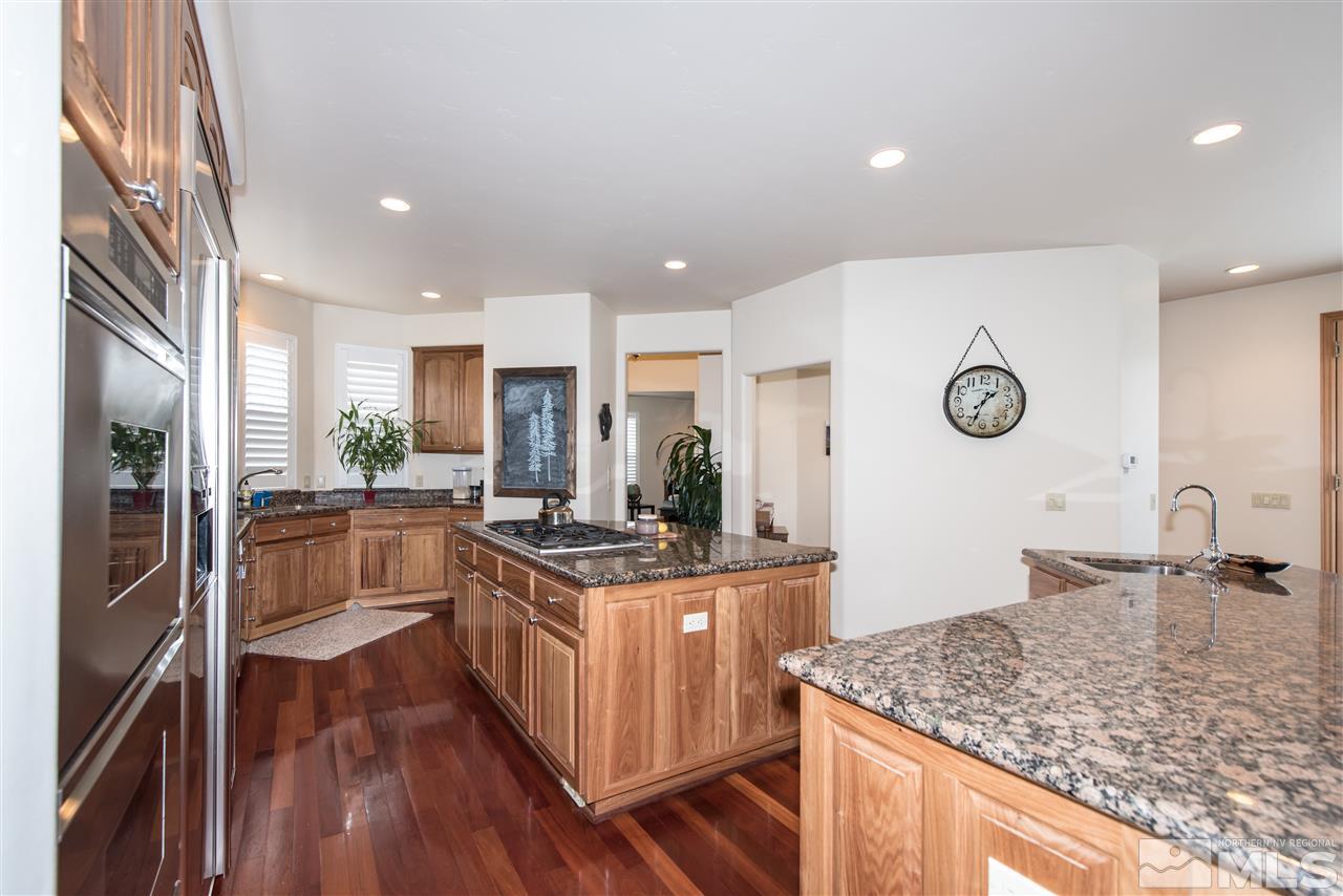 1199 Yates Lane Reno, NV 89509 - Photo 8 of 25 a kitchen with stainless steel appliances granite countertop a sink stove and refrigerator