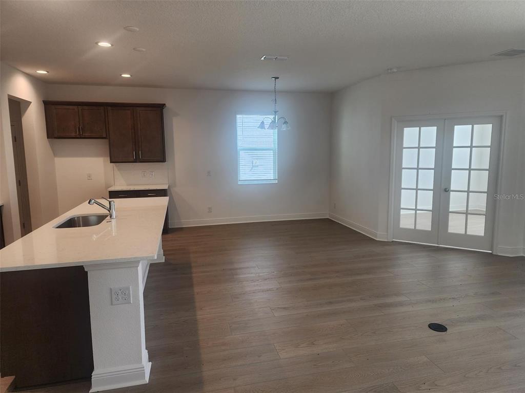 7501 Catania Loop Clermont, FL 34714 - Photo 6 of 12 an empty room with wooden floor and windows