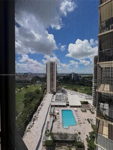 a view of a balcony with floor to ceiling windows