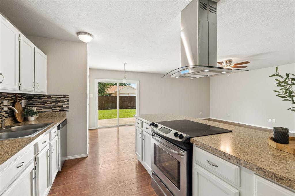 5620 Perrin Street The Colony, TX 75056 - Photo 8 of 31 a kitchen with a stove and a sink