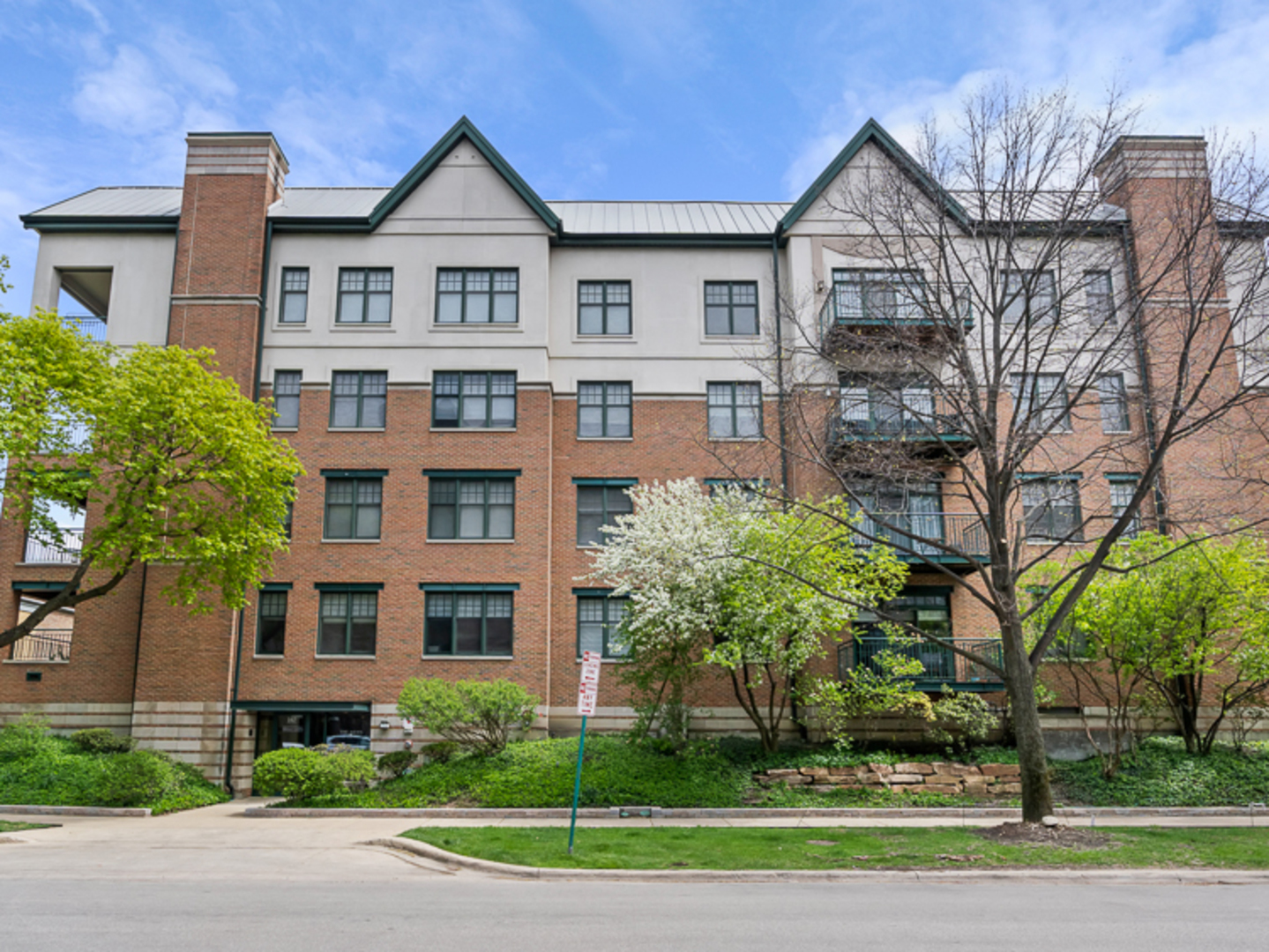 140 North Euclid Avenue, Unit 202 Oak Park, IL 60302 - Photo 1 of 15 a view of a brick house next to a yard with large trees