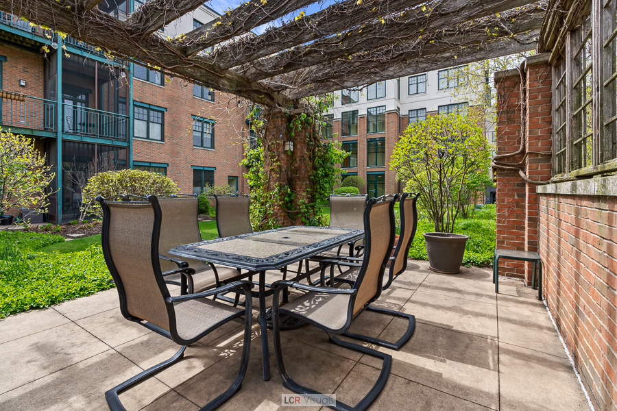140 North Euclid Avenue, Unit 202 Oak Park, IL 60302 - Photo 14 of 15 a patio with table and chairs and potted plants