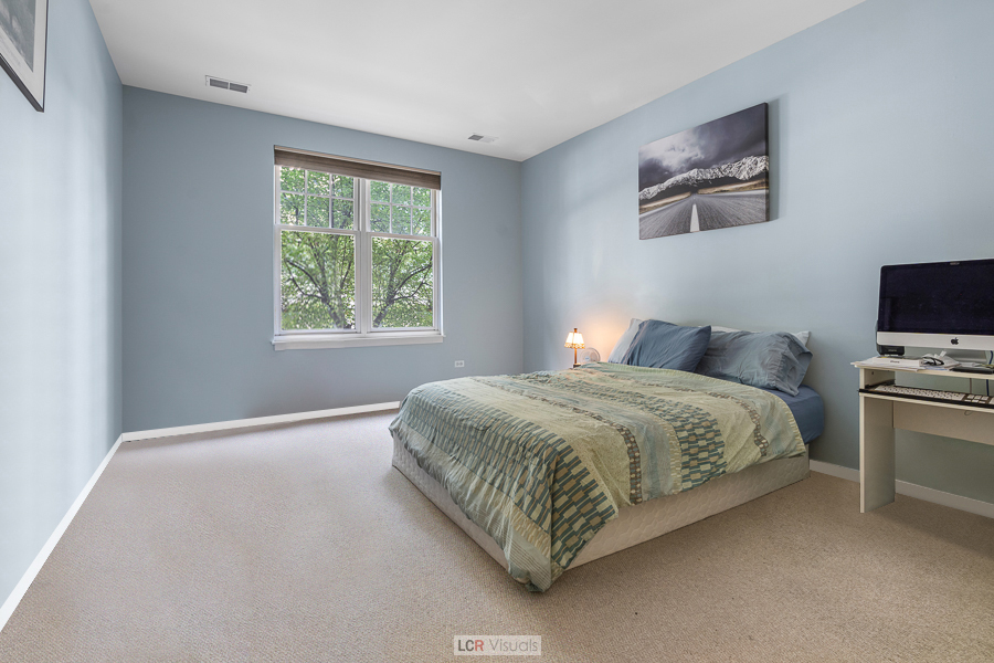 140 North Euclid Avenue, Unit 202 Oak Park, IL 60302 - Photo 6 of 15 a bedroom with a bed and a flat screen tv